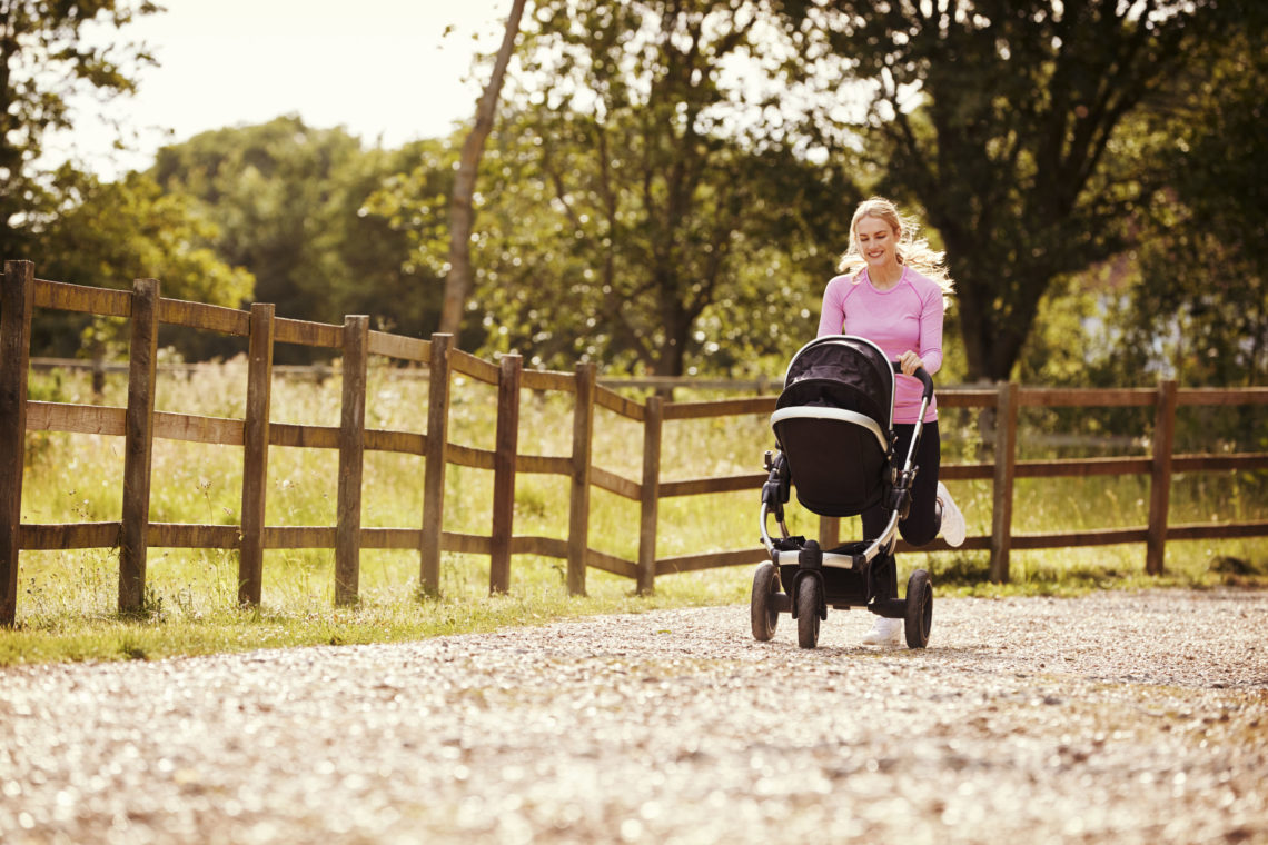 Mother Exercising By Running and Pushing a Baby Buggy